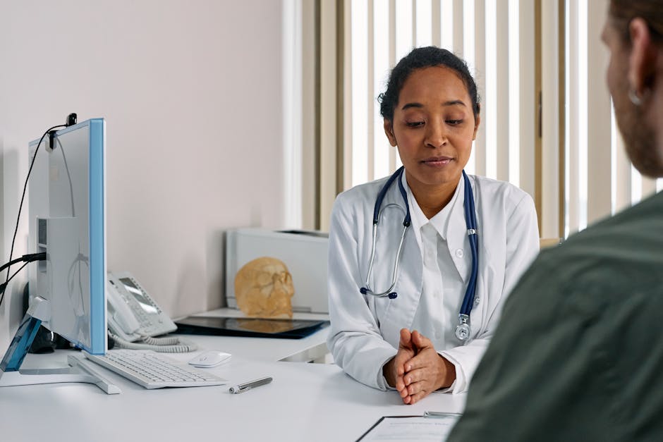 Female doctor consulting a female patient in a modern medical office, discussing perimenopause symptoms