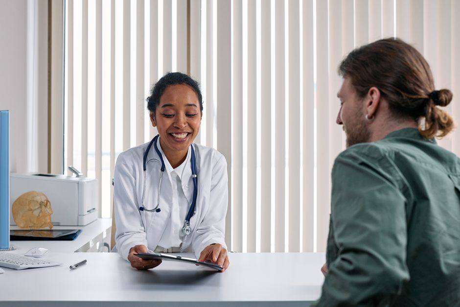 Female doctor and woman patient having a positive well-woman consultation in a bright clinic